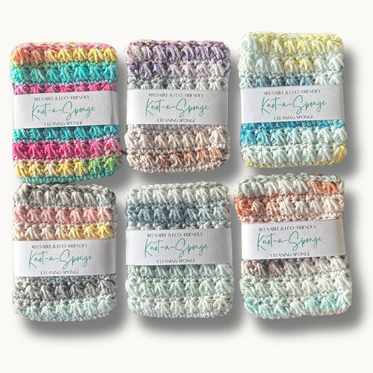 six kitchen sponges made of cotton yarn in variety of colors on a solid background with a label that says reusable & eco-friendly knot-a-sponge cleaning sponge