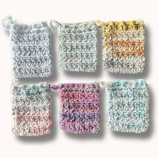 A collection of colorful cotton soap pouches with a crochet design and a drawstring closure.