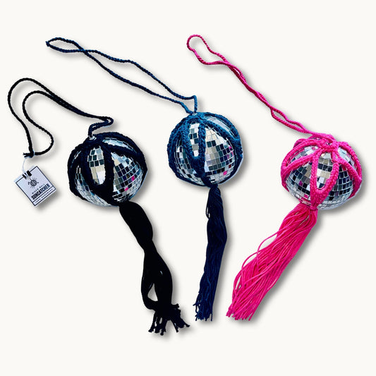 Three handmade crochet sun catchers with a 4-inch mirrored disco ball, one with a black tassel, one with a blue tassel, and one with a pink tassel, all designed to hang.
